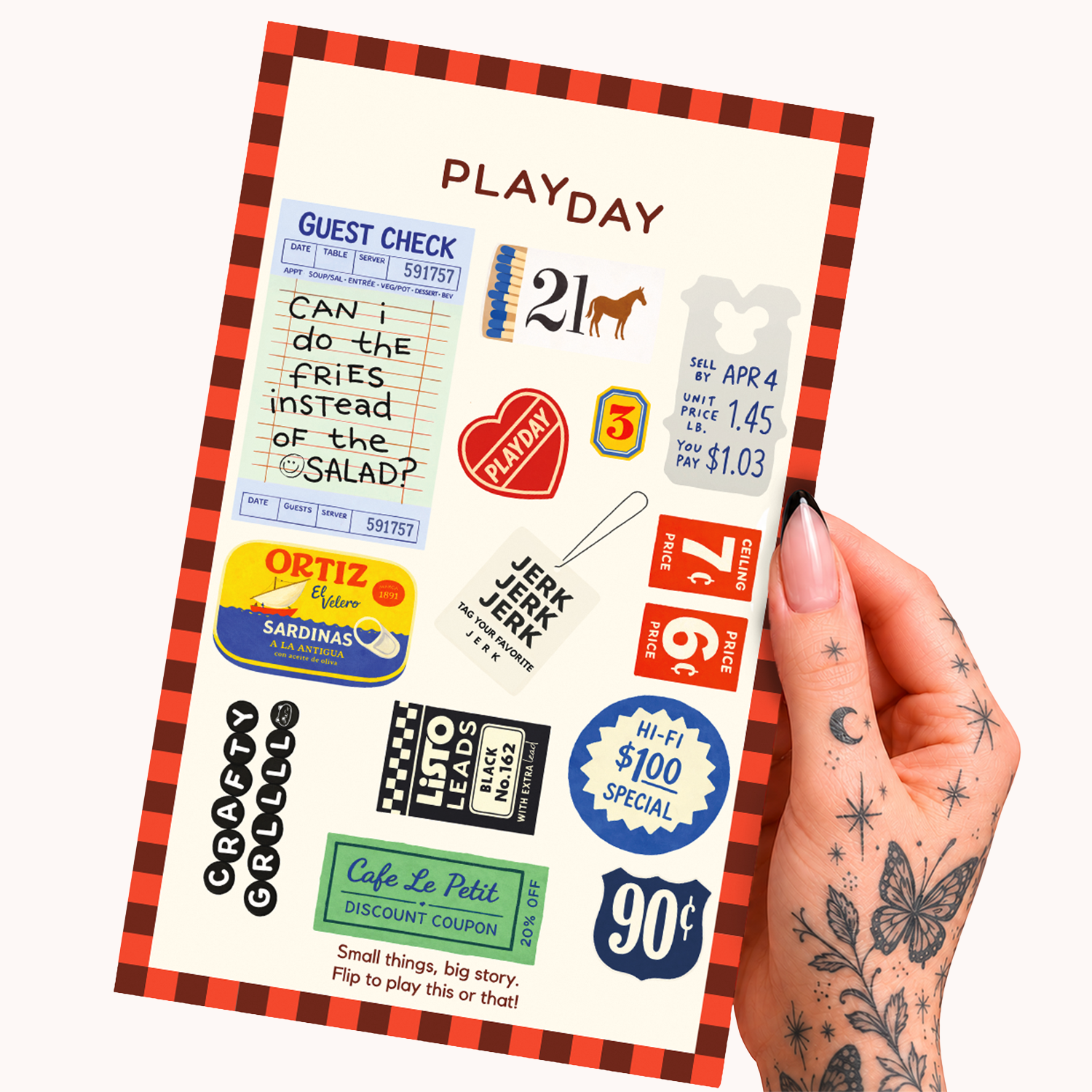 A hand with floral tattoos holds a PLAYDAY brand sticker sheet featuring retro-style junk journal designs in red, blue, green, yellow, and white on a cream background.