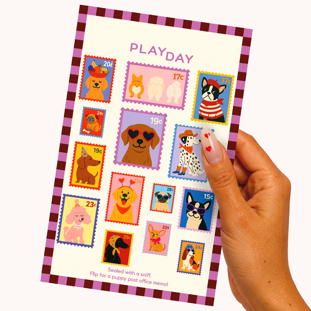 A hand holds a sticker sheet featuring colorful illustrated dog stamps and a pink-and-purple checkered border on a light background.